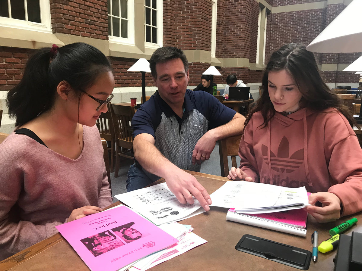 Teacher helping students with coursework at SAIT — SAIT